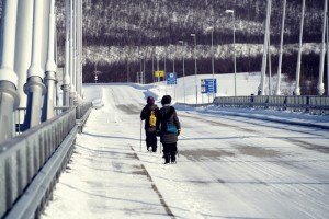 My friends crossing the bridge heading to Norway